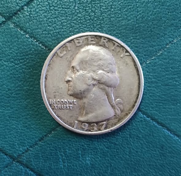 1937 Washington quarter close-up showing a raised die crack line running across the coin surface